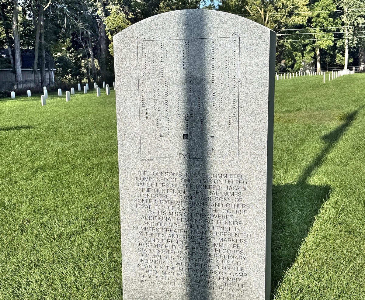 A granite monument at the Confederate Stockade Cemetery engraved with the plan of located graves above an inscription describing the work of the Johnson's Island Committee.